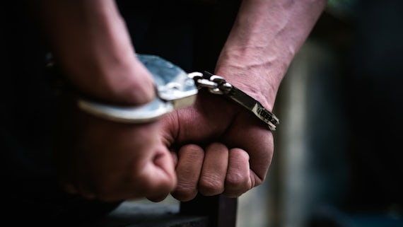 Stock image of person in handcuffs
