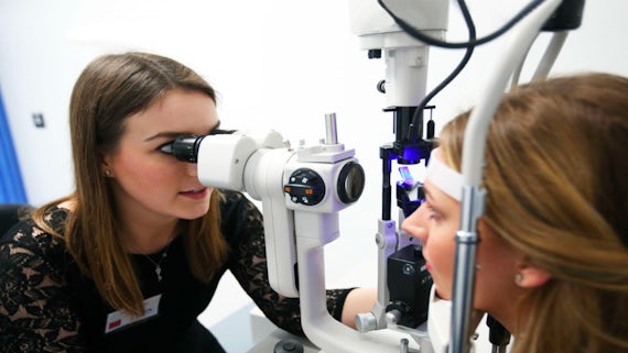 Optometrist conducting eye examination