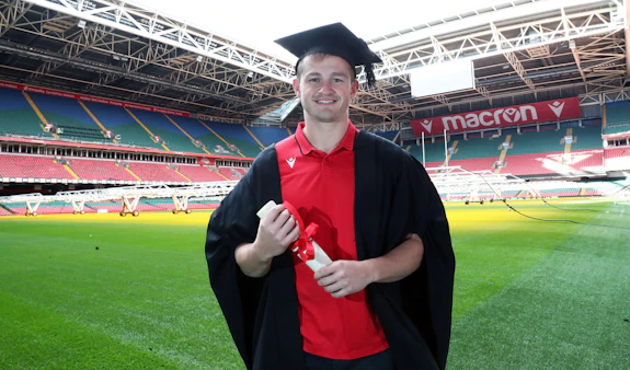 Hallam Amos wearing graduation gown in Principality Stadium