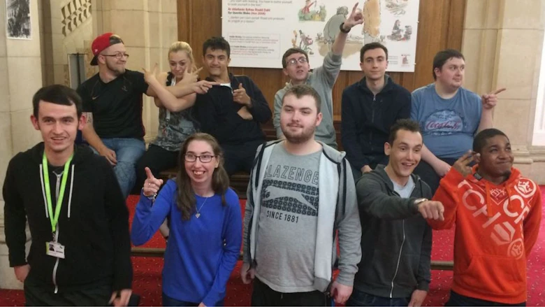 Young people standing in front of a poster