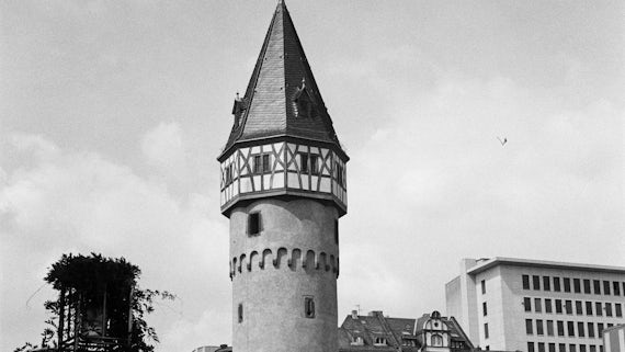 A black and white image of an old circular tower building.