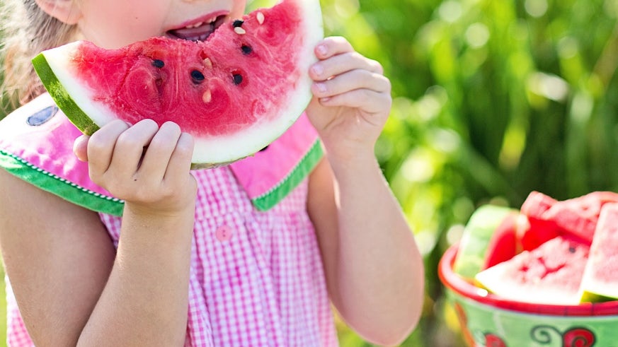 Child eating a slice of watermelon