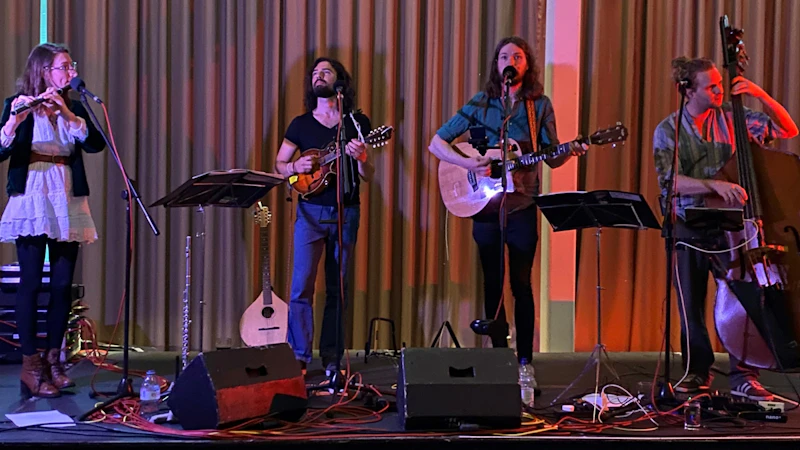 A band of 4 people playing instruments