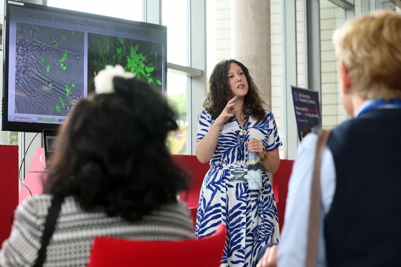 An image of a scientist giving a talk to a crowd