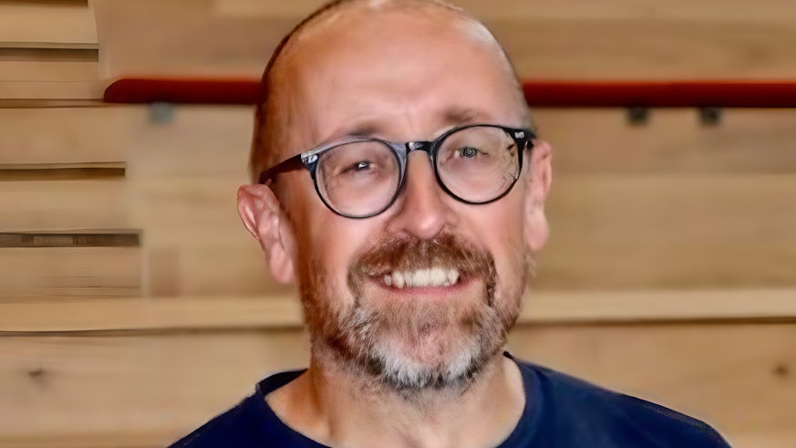Man posing for a headshot, smiling