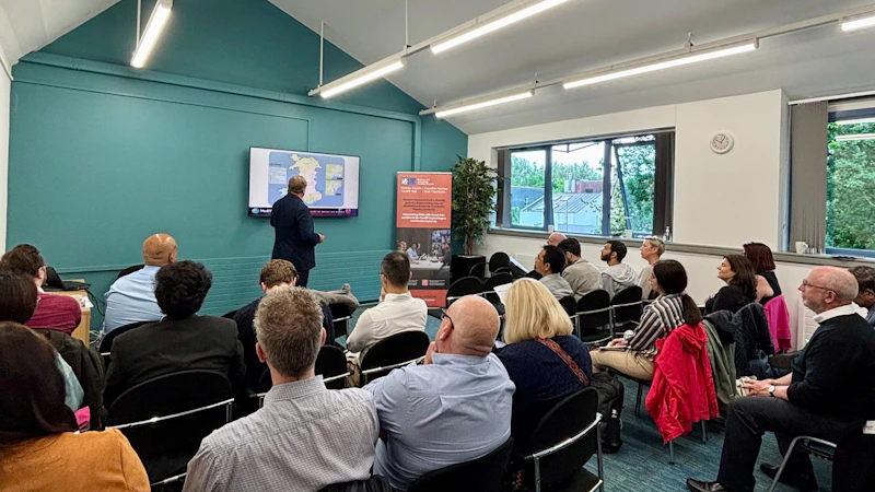 People watch a man give a presentation about AI in healthcare