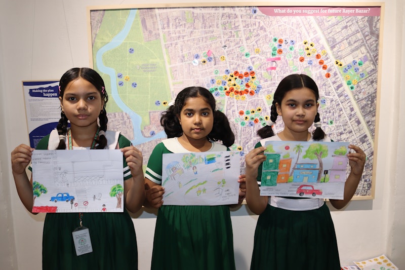 Three children stand together.