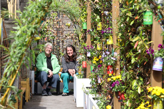 Two women sitting in a garden.