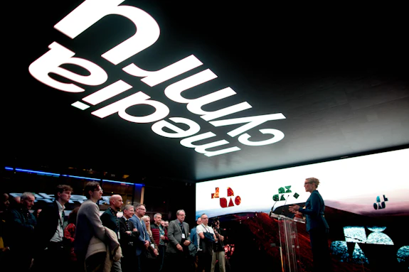 A person speaking in front of a crowd
