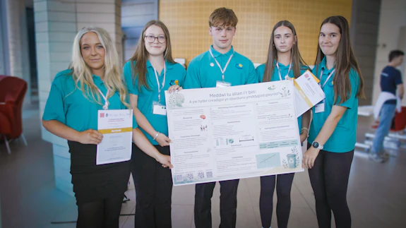 Winning team Ysgol Gyfun Gwyr holding their research poster