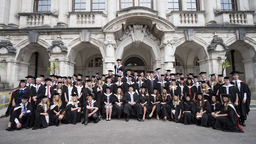 Group photo of graduating students outside Main Building