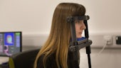 Woman with her head in a cognitive testing device