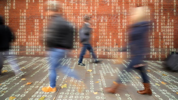 Image of people walking about in a world surrounded by streams of data