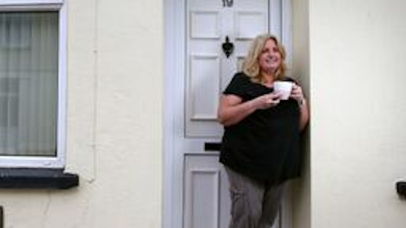 Female resident merthyr holding cup of tea