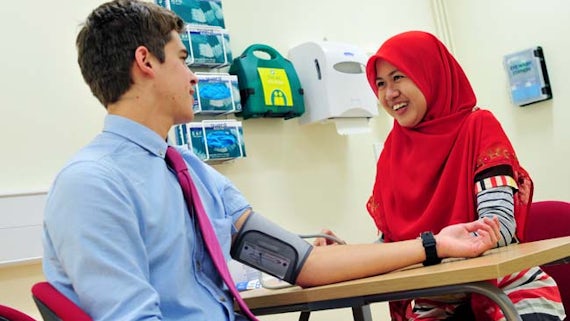 Students taking blood pressure