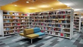 Bookshelves and seating area inside the Central Square Library building