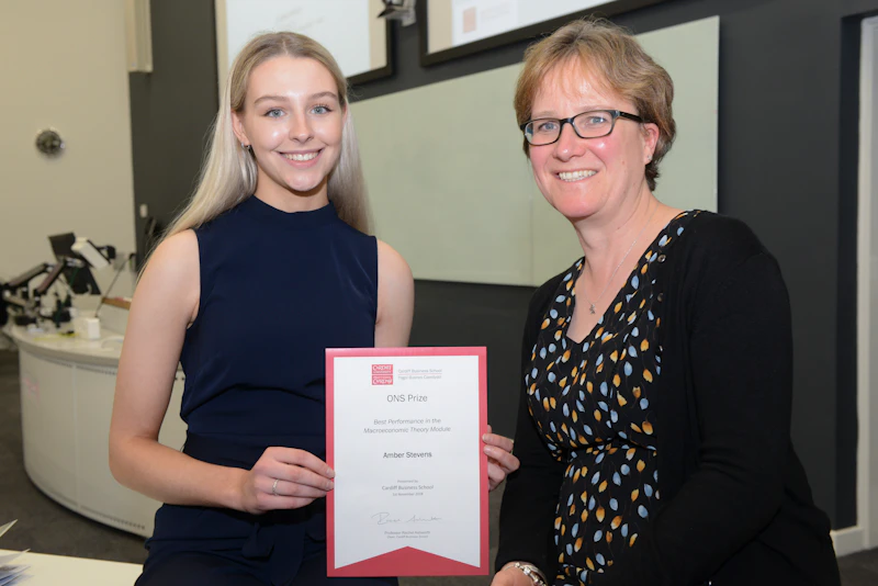 Two women with certificate