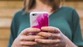 Woman using pink smart phone