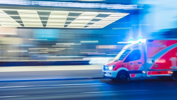 Ambulance driving at speed, slightly blurry to indicate speed speed