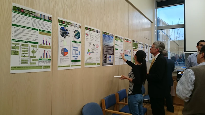 PhD student discussing poster