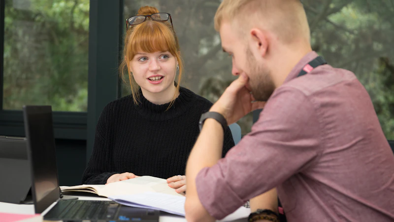 Two students working and talking