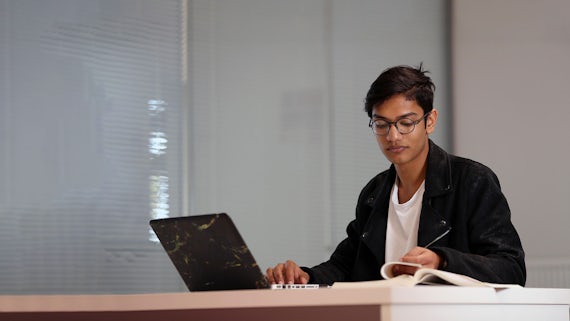 Student sitting at a laptop.
