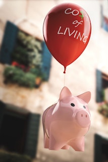 Piggy bank being carried away by a balloon
