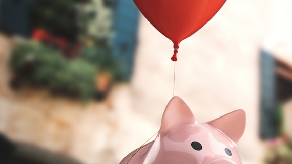 Piggy bank being carried away by a balloon