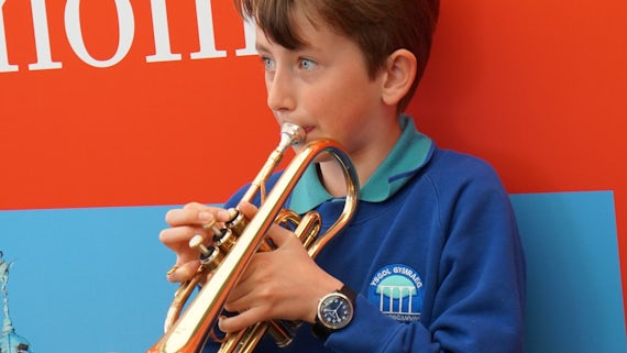 A competitor rehearsing before competing in the brass instrumentalist competition.