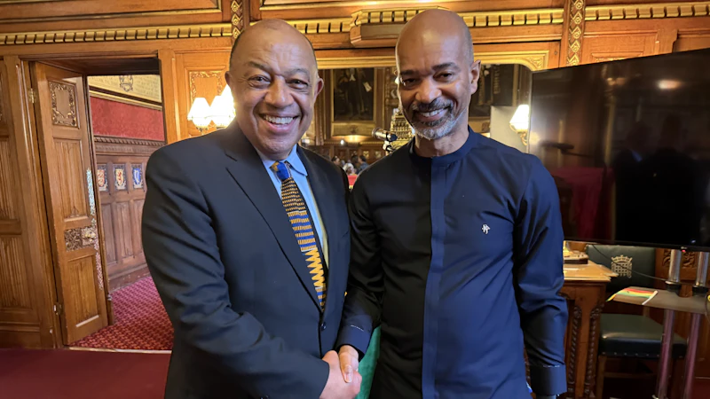 Two people smiling and shaking hands