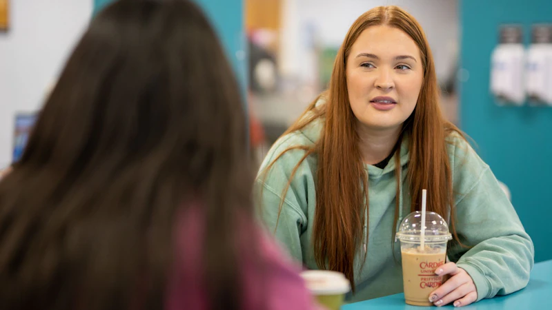 Image of students talking over coffee