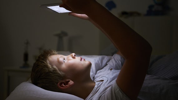 Child using smartphone at night