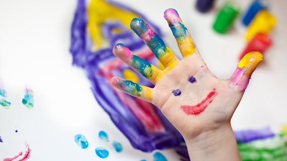 Child's hand covered in paint