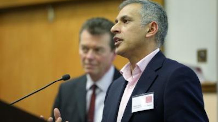 Abdul Rahim speaking at a Vision 2020 network event, with Jasper Hemmes standing behind