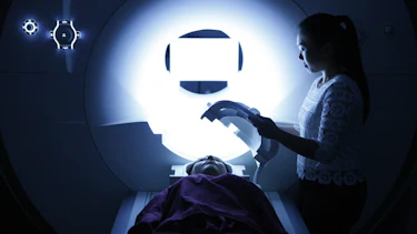 Student helping a study participant prepare for a brain scan