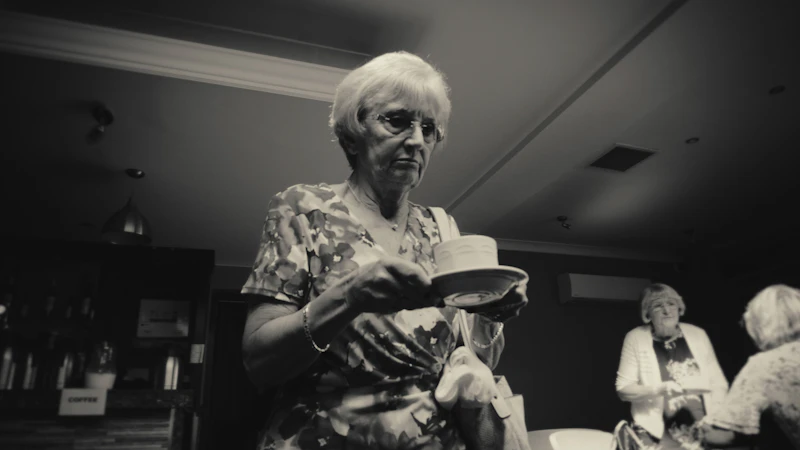 Woman carrying a cup of tea