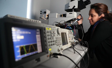 Research worker in optics lab