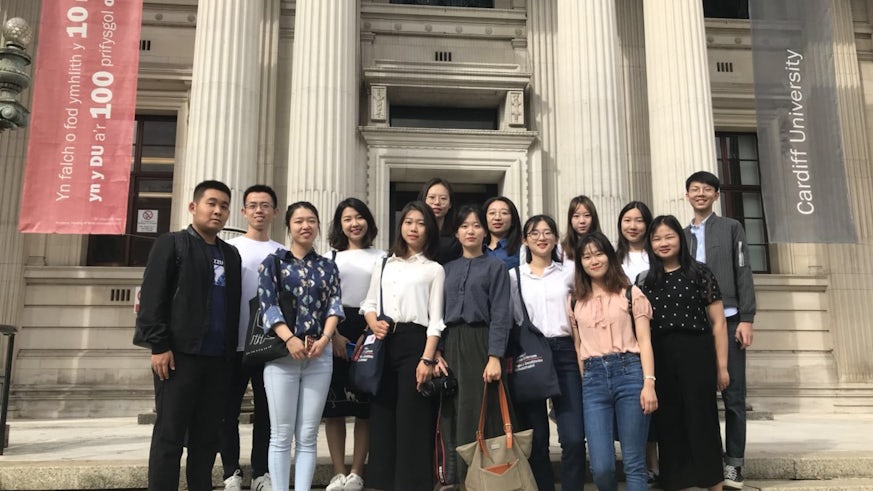 Students from Beijing Normal University standing outside Glamorgan Building, Cardiff University