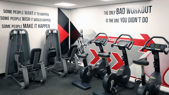 Exercise bikes with inspirational quotes on the wall. 