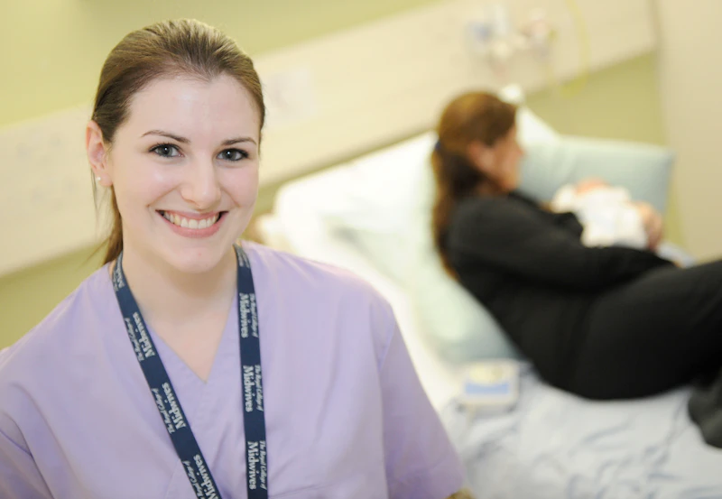 Female midwifery student in lilac tunic.