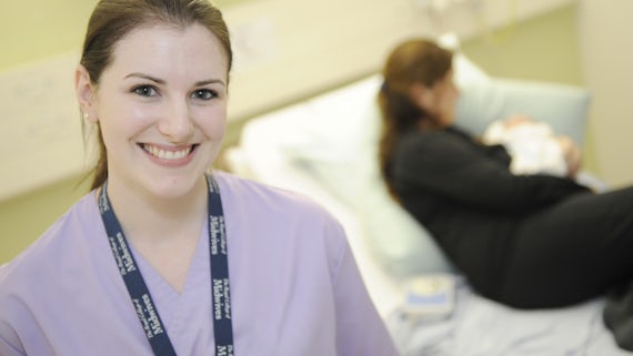 Female midwifery student in lilac tunic.