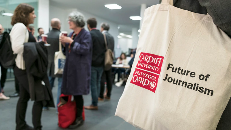 A person holds a bag with Future of Journalism written on it at the 2017 conference.