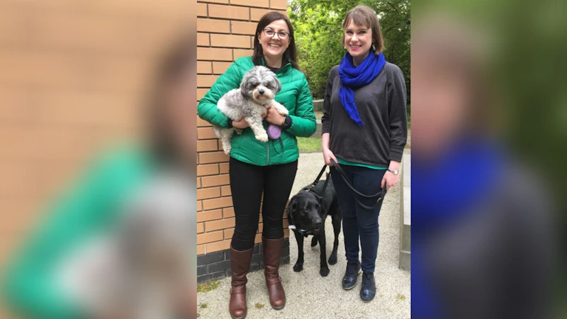 Two women with their dogs