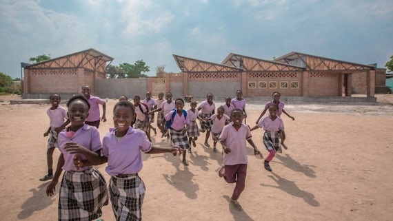 Image of school children running towards the camera