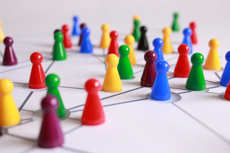Small plastic pieces set up to represent people in a organisational diagram  