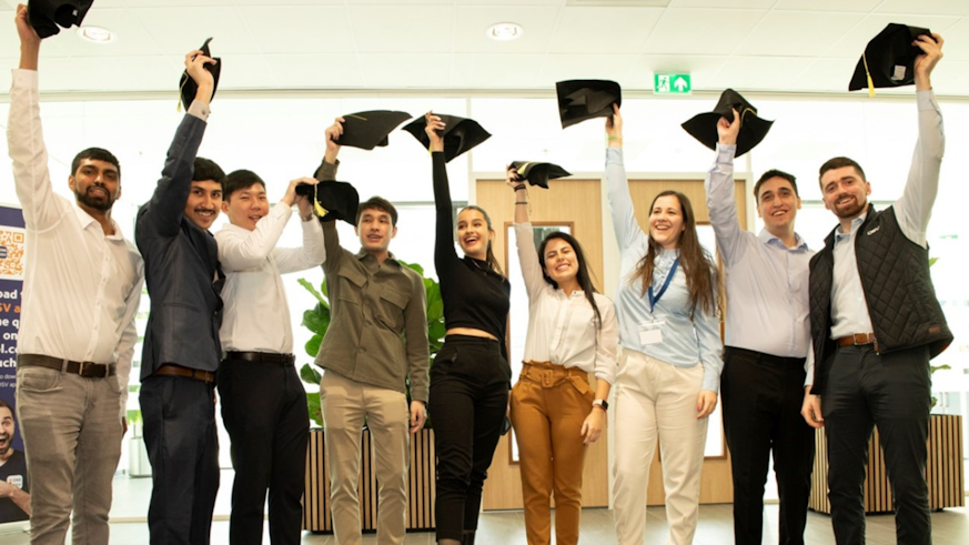 DSV Accelerate Programme Graduates throw graduation caps in the air