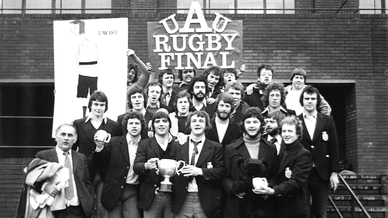 A group of men celebrating on the old SU steps