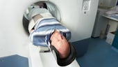 A patient exits the PET scanner