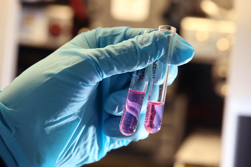 Hand holding two test tubes