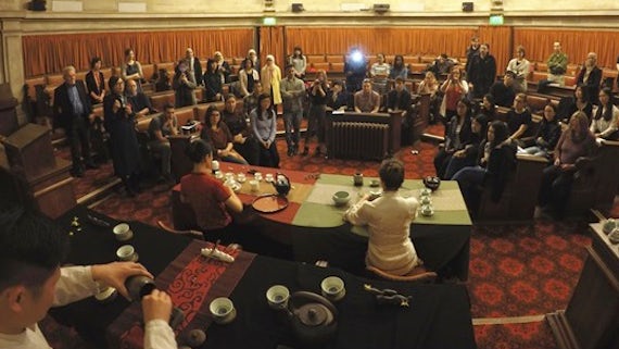 People watch a demonstration of tea making